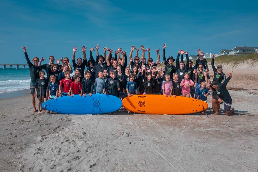 Group picture of everyone from a week of surf camp last summer.